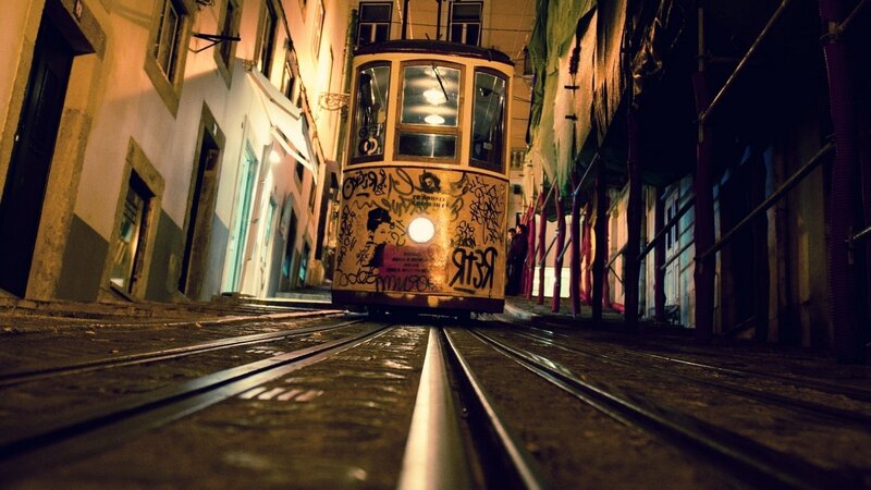 Tram on a narrow street at night