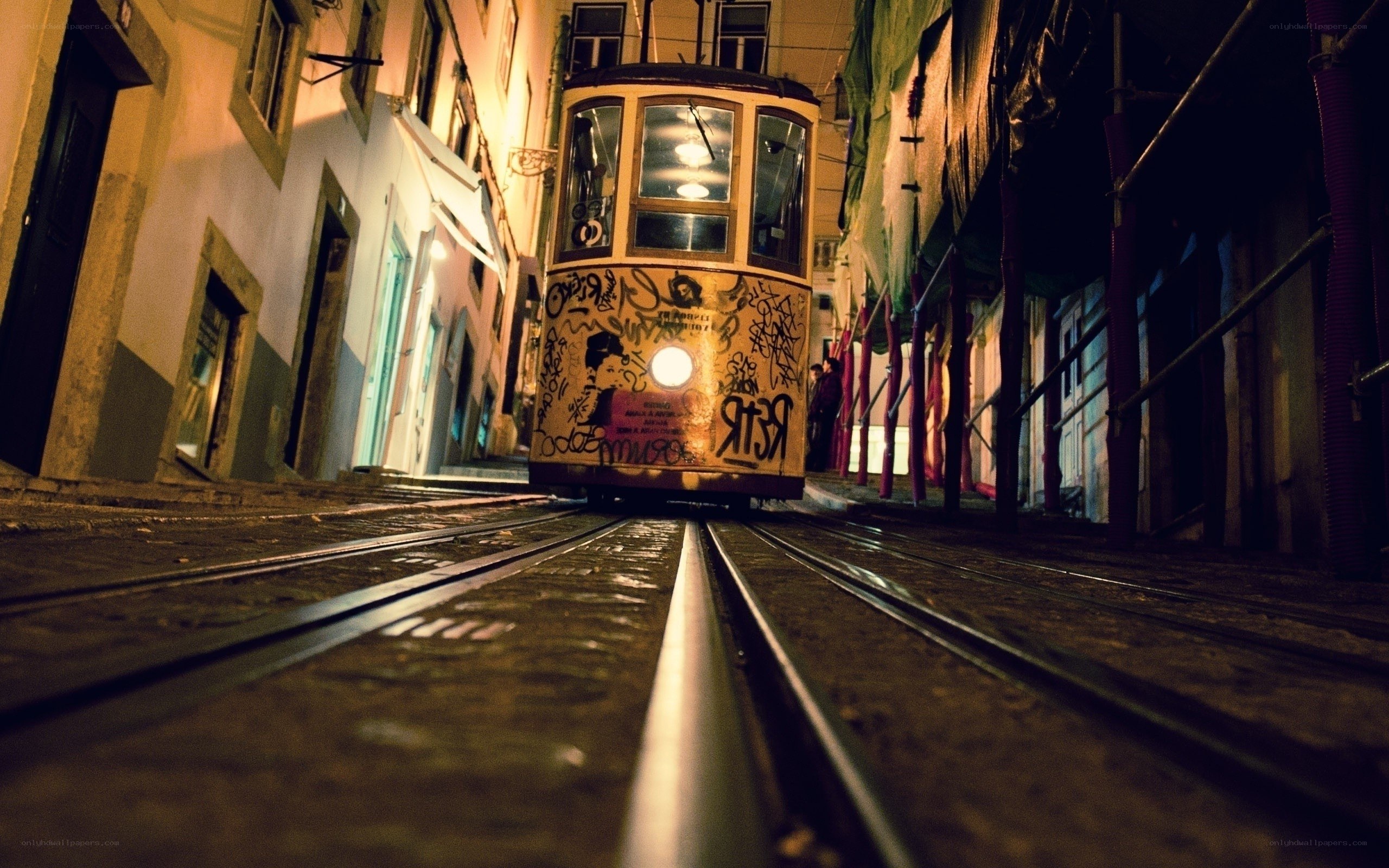 Tram on a narrow street at night