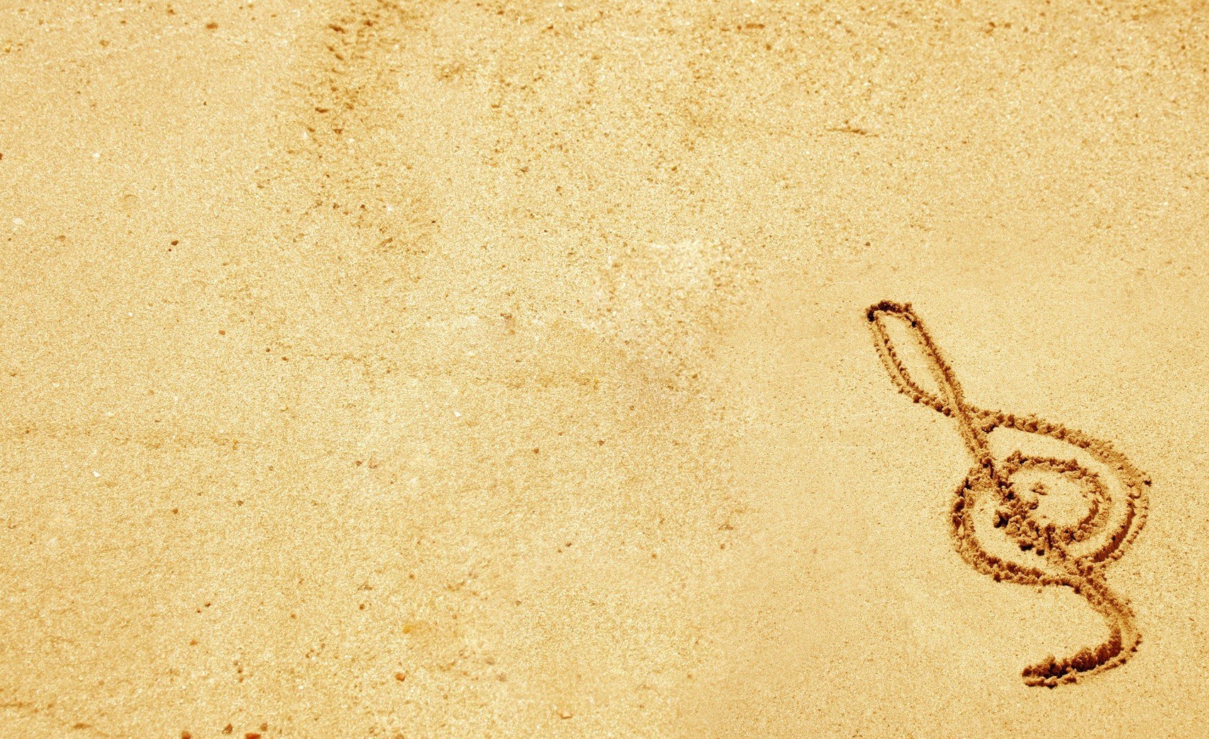 treble clef drawn in sand