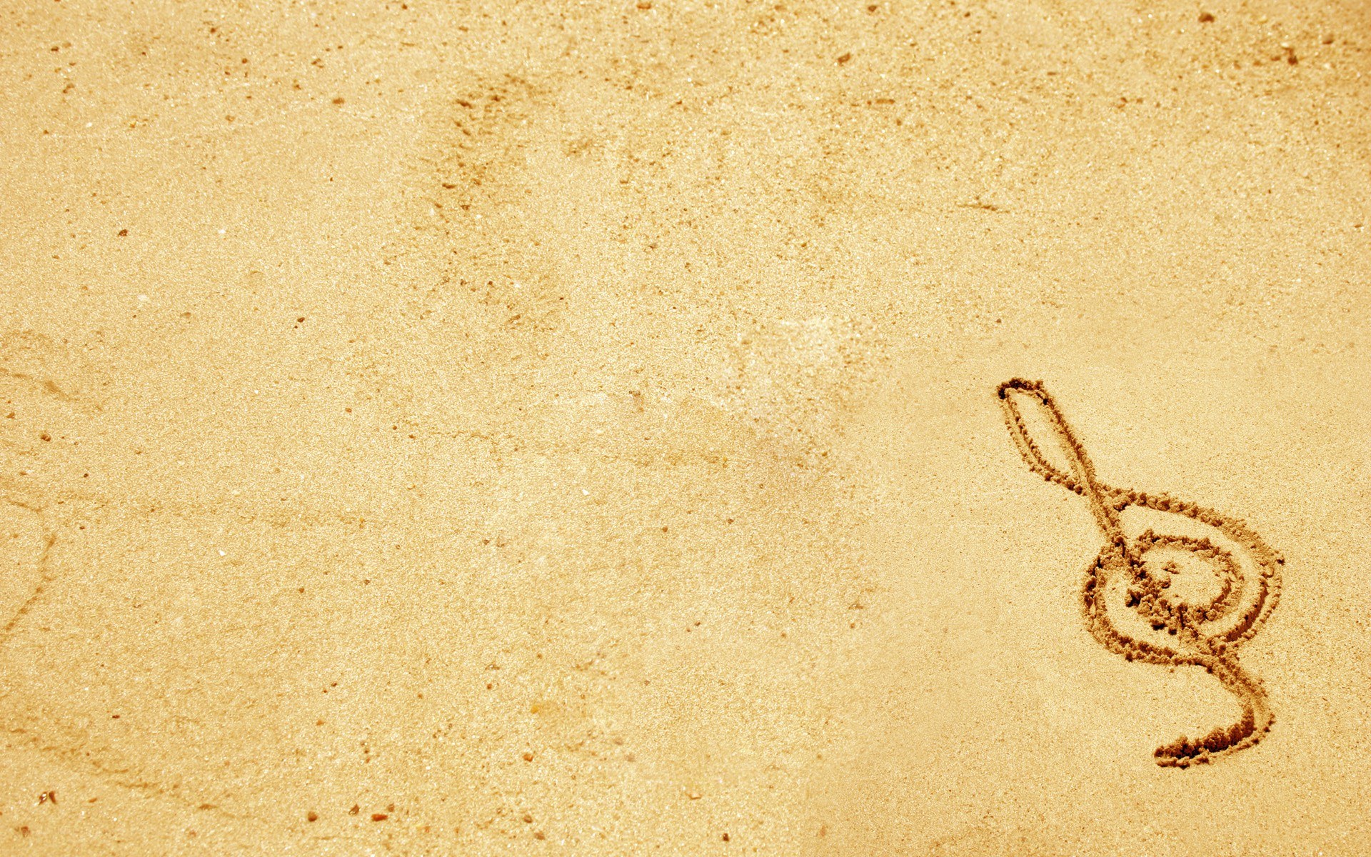 treble clef drawn in sand