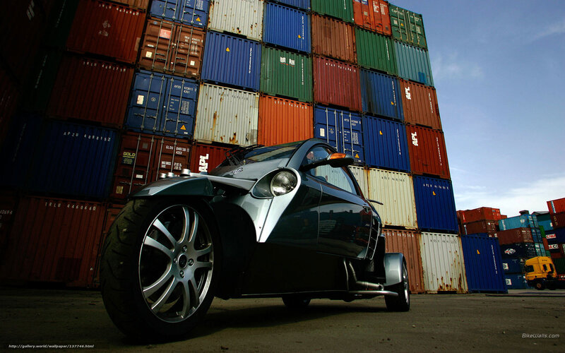 Trike in front of shipping containers