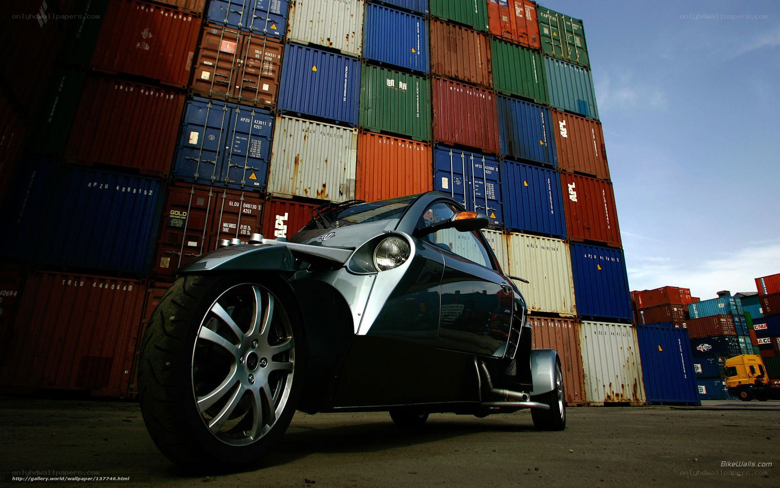 Trike in front of shipping containers