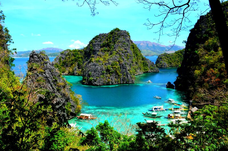 Tropical Bay with Boats — Blue, Serene, Afternoon, Photograph, Limestone Cliffs