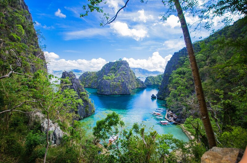 Tropical Bay with Limestone Cliffs — Blue, Serene, Afternoon, Photograph, Boats