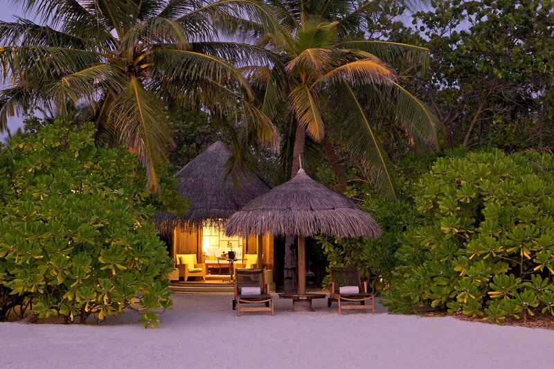 Tropical beach bungalow at dusk