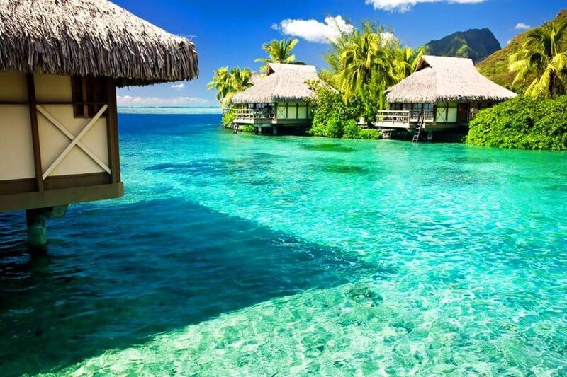 Tropical Beach Bungalows — Blue, Serene, Afternoon, Photograph, Thatched Roofs