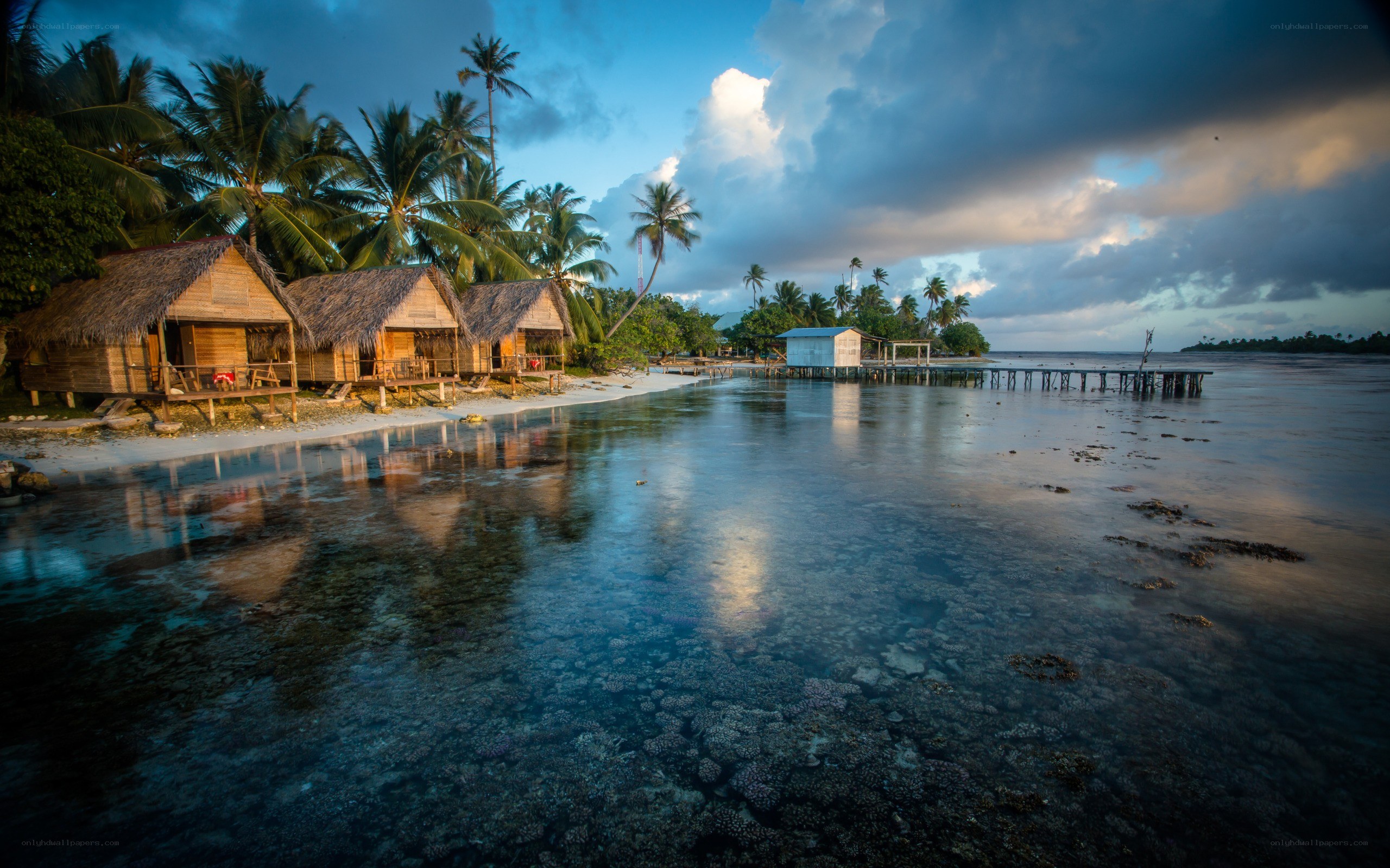 Tropical beach huts at sunset