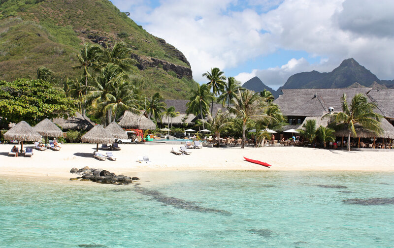 Tropical Beach Resort — Blue, Serene, Afternoon, Photograph, Palm Trees, Thatched Roofs, Mountains