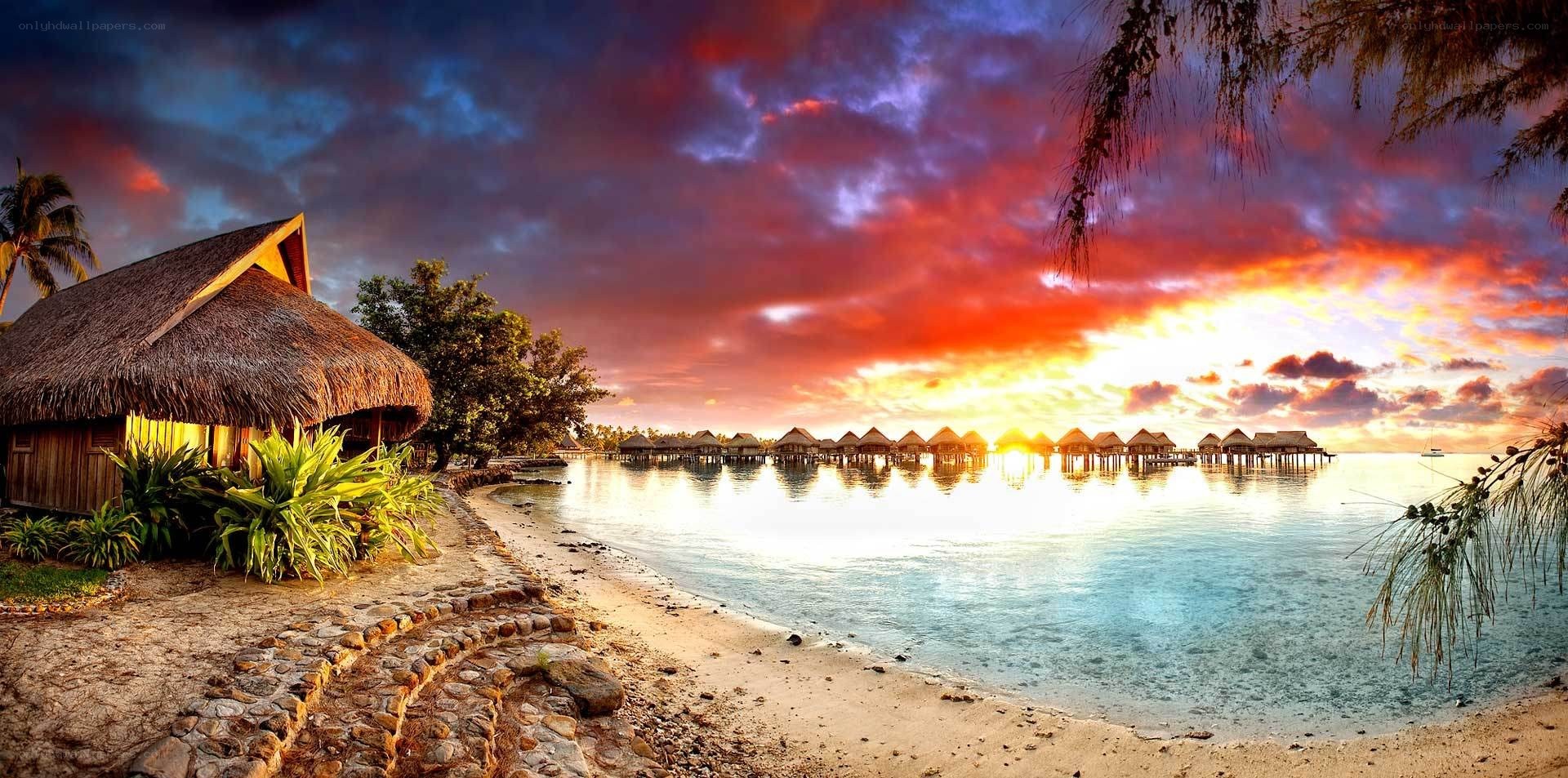 Tropical beach sunset with bungalows