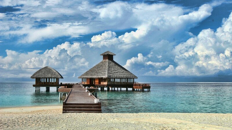Tropical beach villas with wooden pier