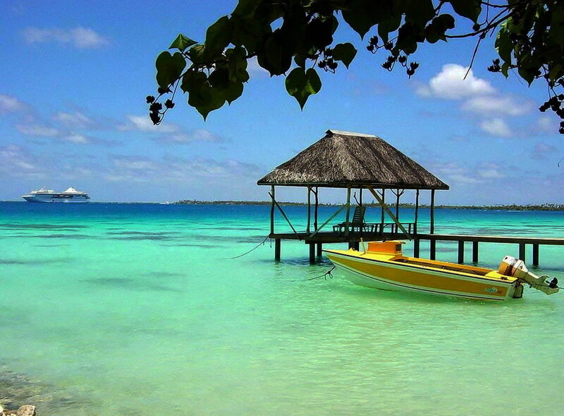 Tropical beach with boat and hut