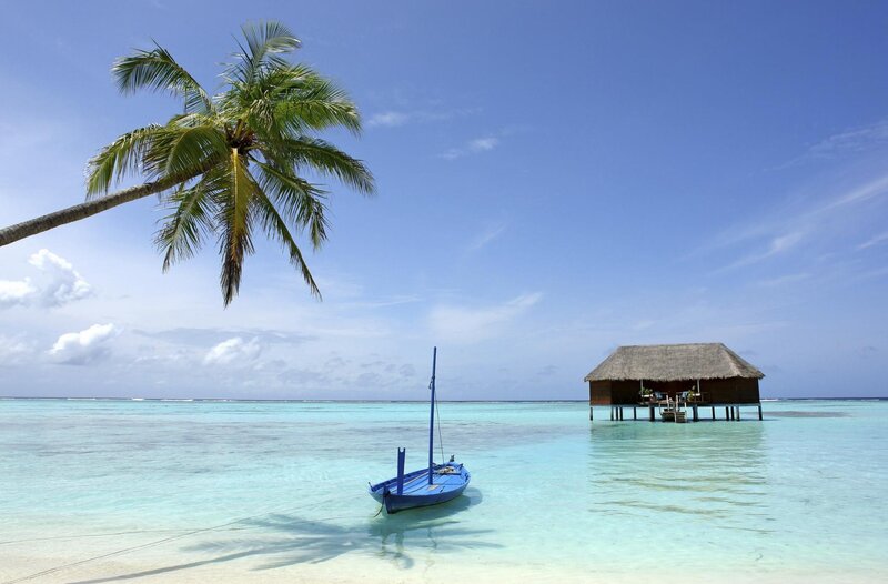 tropical beach with boat and hut