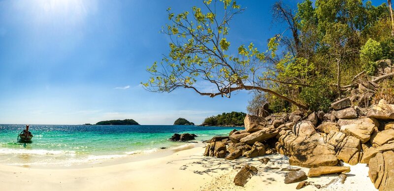 tropical beach with boat and island