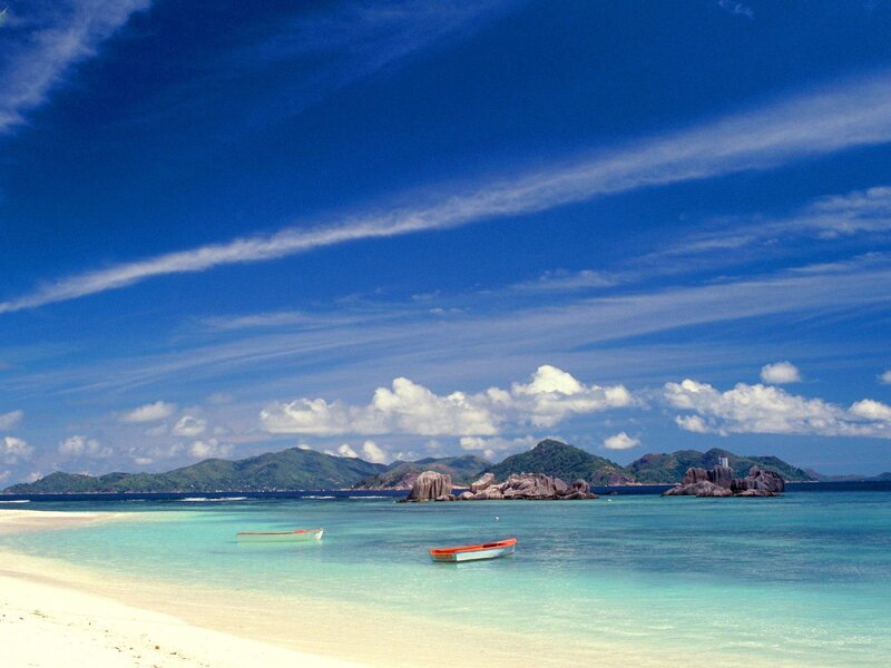 Tropical beach with boats and islands