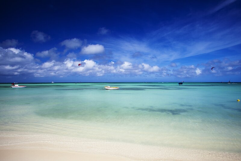 Tropical Beach with Boats — Blue, Serene, Afternoon, Photograph, Kites, Clouds