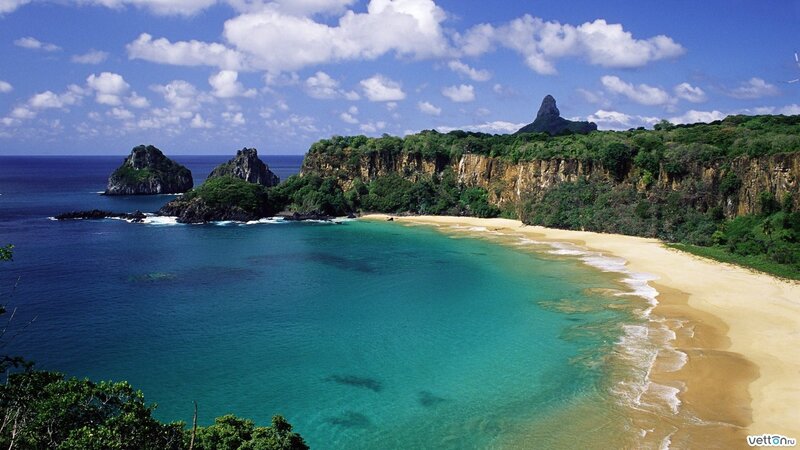 tropical beach with cliffs and rocks