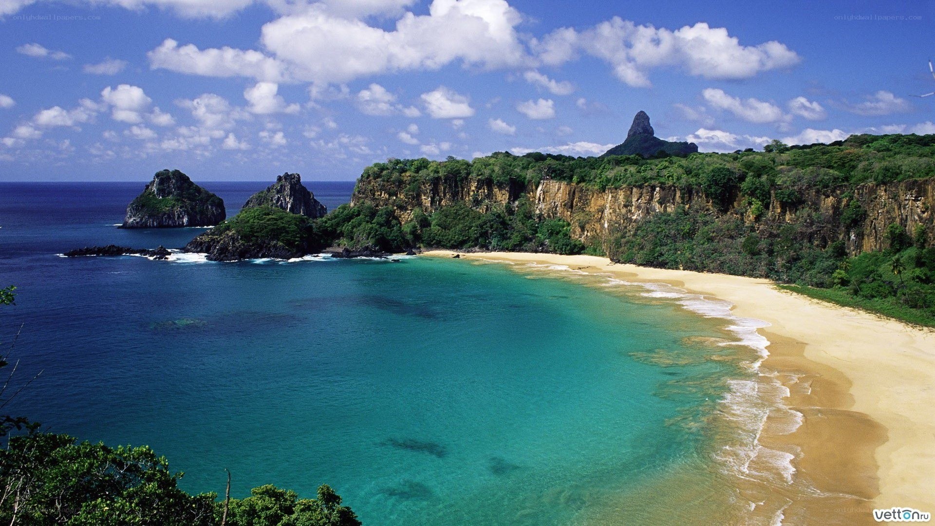 tropical beach with cliffs and rocks