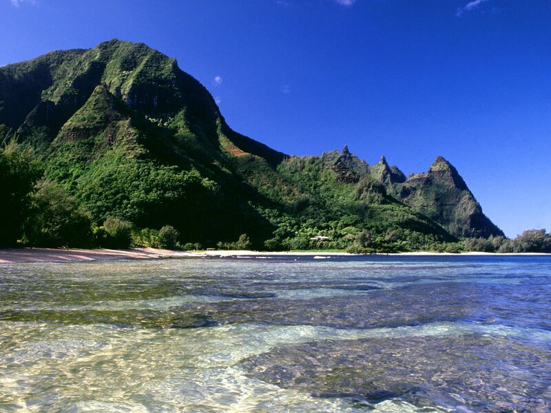 tropical beach with green mountains