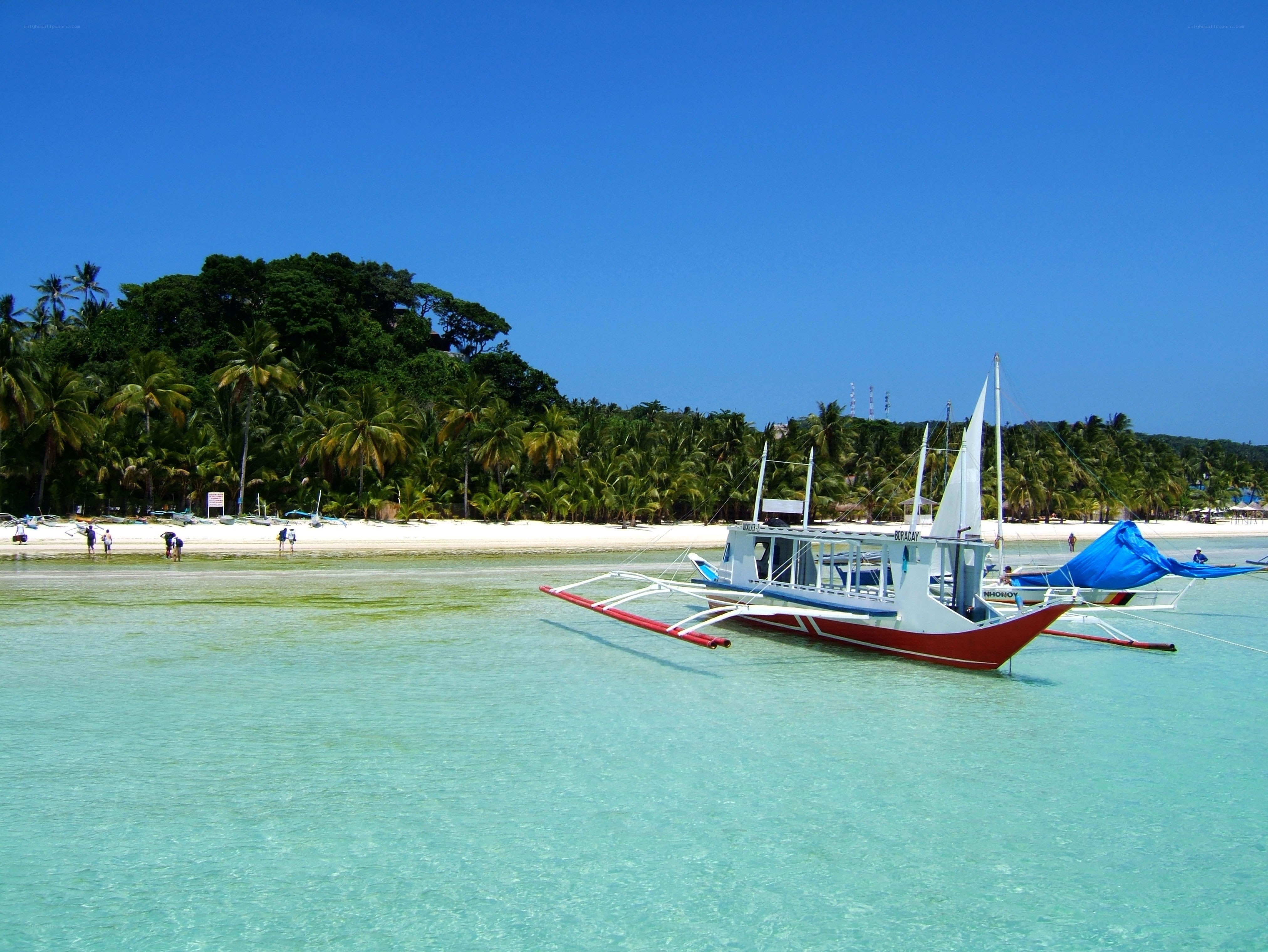 tropical beach with outrigger boat