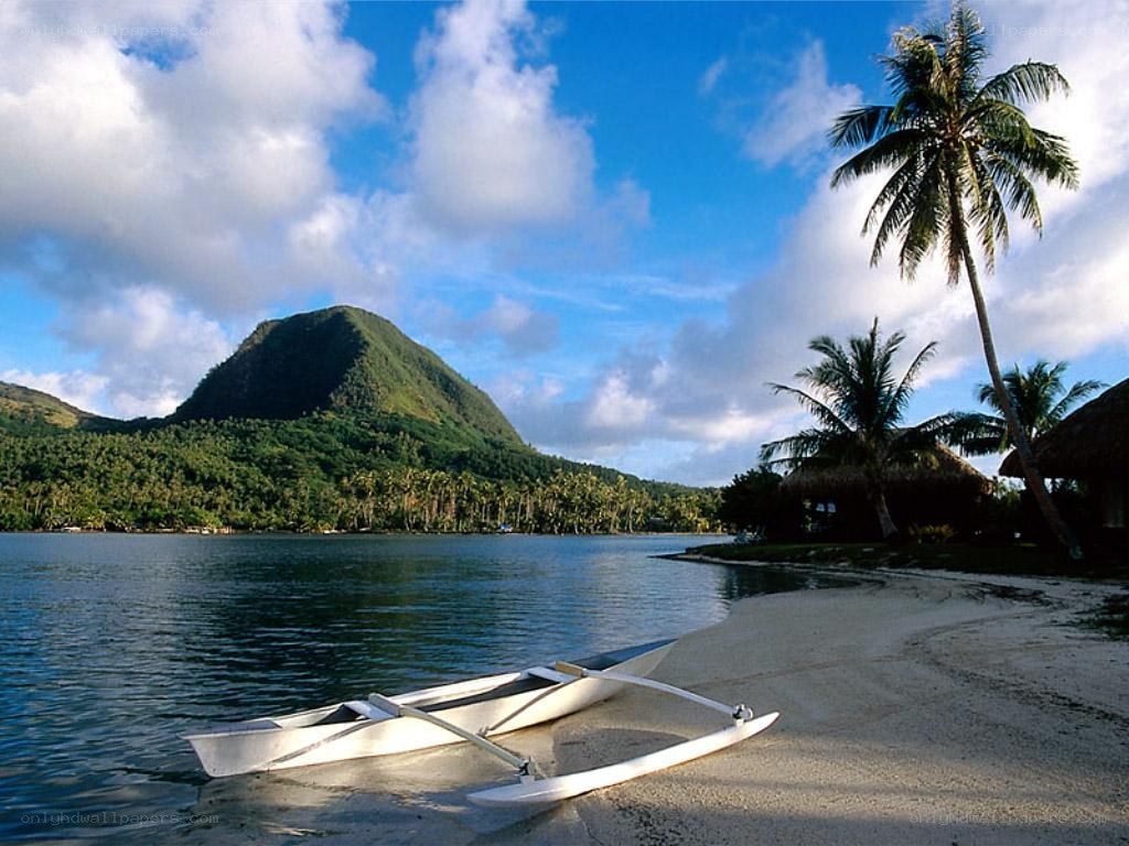 tropical beach with outrigger canoe