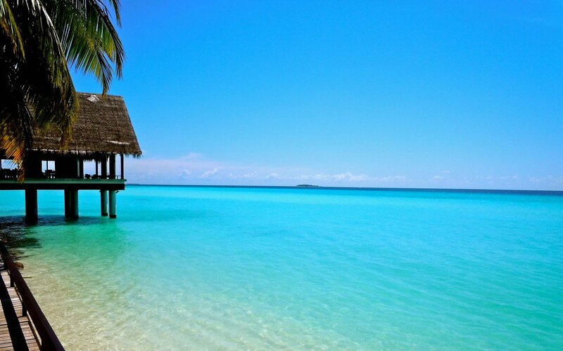 tropical beach with overwater bungalow