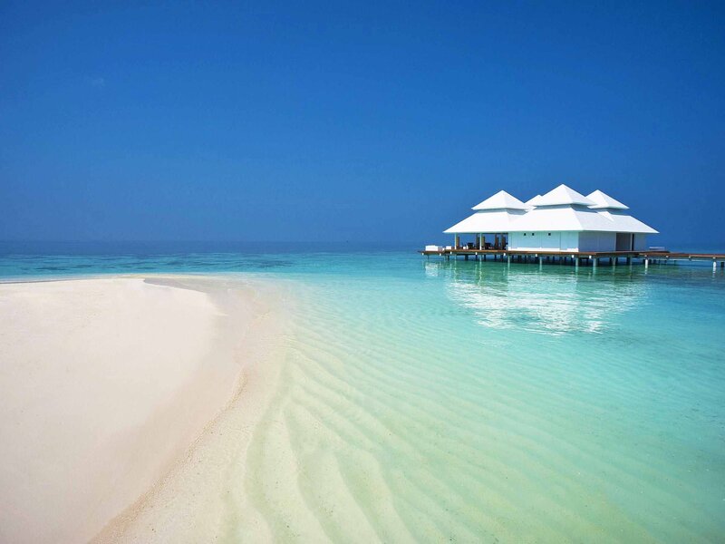 Tropical beach with overwater bungalow
