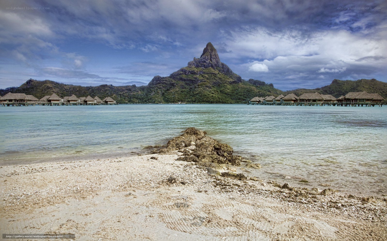 Tropical beach with overwater bungalows