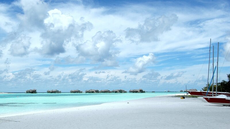 tropical beach with overwater bungalows