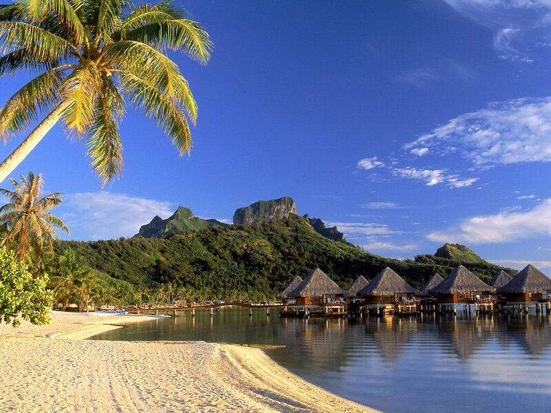 Tropical beach with overwater bungalows