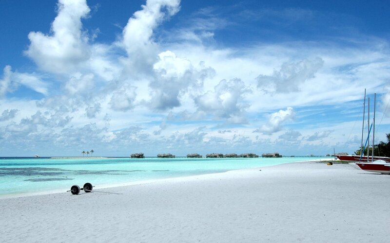tropical beach with overwater bungalows