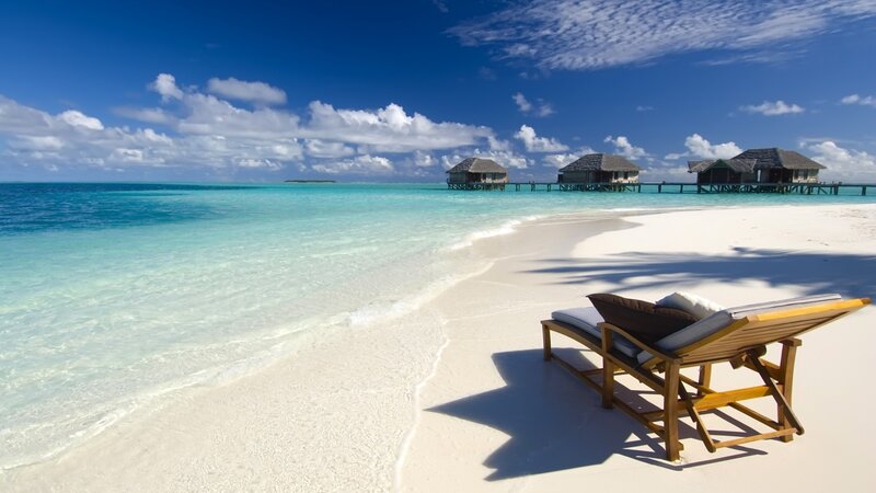 Tropical beach with overwater bungalows
