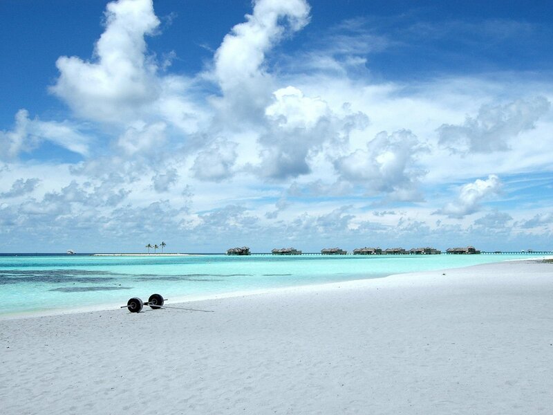 tropical beach with overwater bungalows
