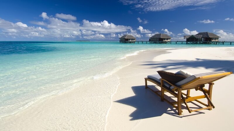 tropical beach with overwater bungalows