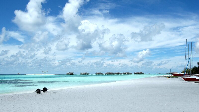 tropical beach with overwater bungalows