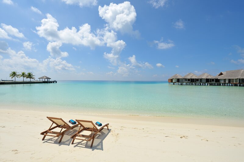 Tropical beach with overwater bungalows