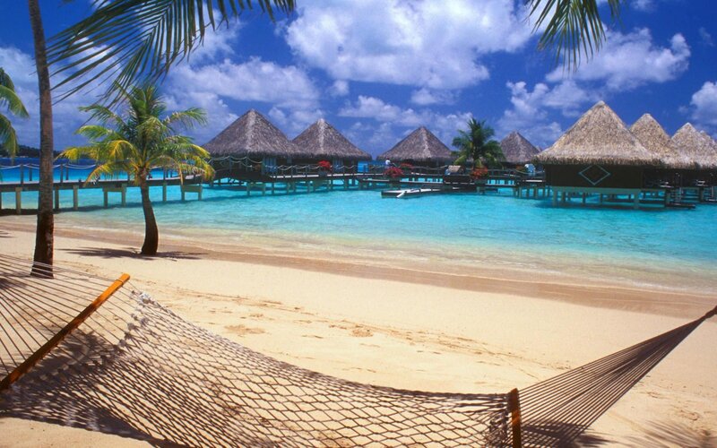 Tropical beach with overwater bungalows