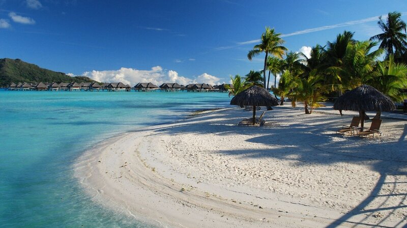 tropical beach with overwater bungalows