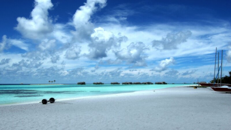 tropical beach with overwater bungalows