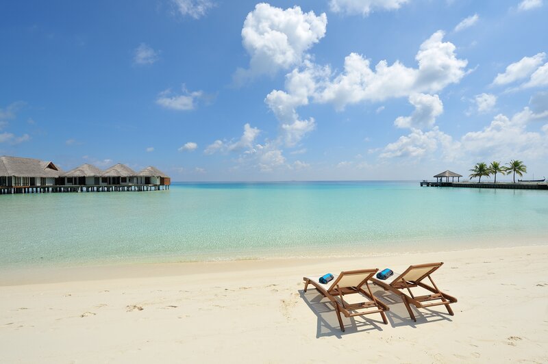 Tropical beach with overwater bungalows