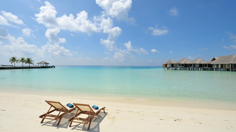 Tropical beach with overwater bungalows