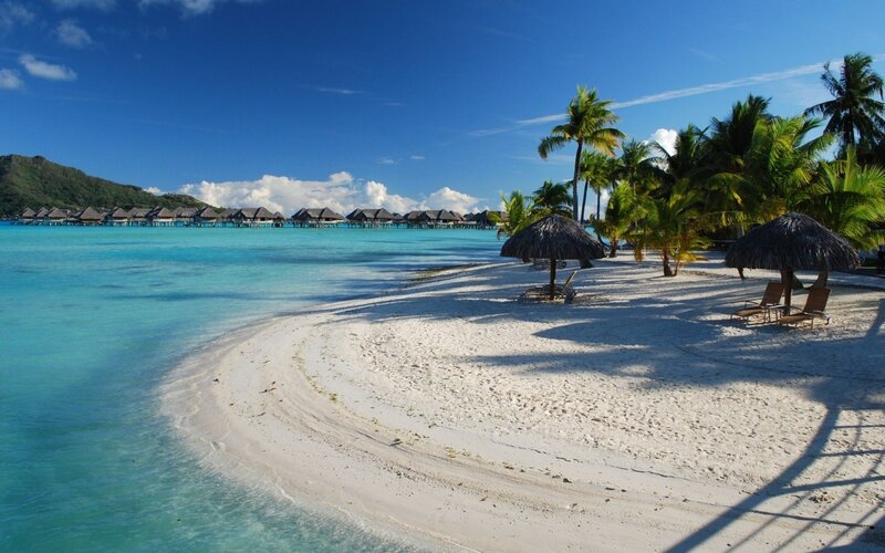 tropical beach with overwater bungalows