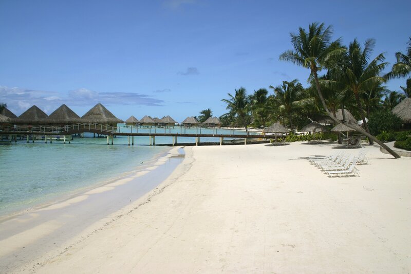 tropical beach with overwater bungalows