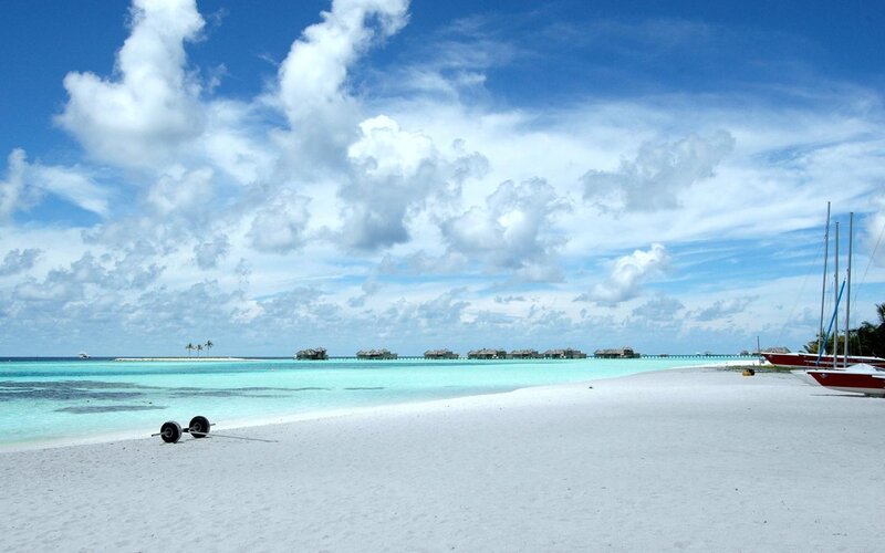 tropical beach with overwater bungalows