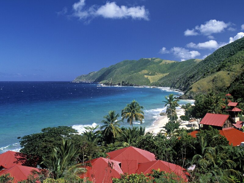 tropical beach with red-roofed buildings