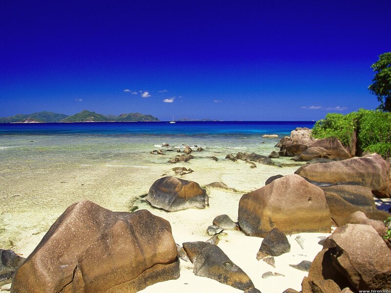 tropical beach with rocks and blue water