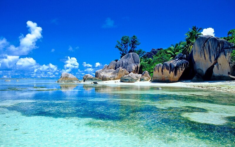 Tropical Beach with Rocks — Blue, Serene, Afternoon, Photograph, Palm Trees, Clouds