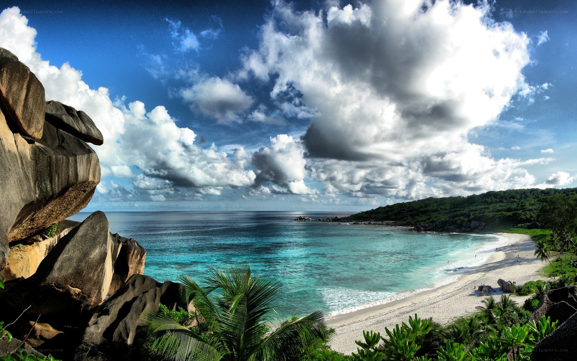 tropical beach with rocky cliffs