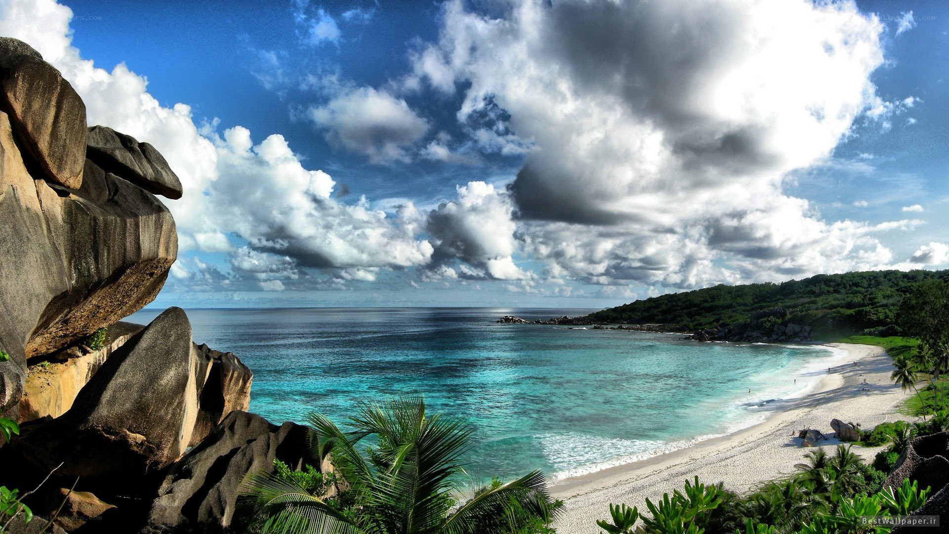 tropical beach with rocky cliffs