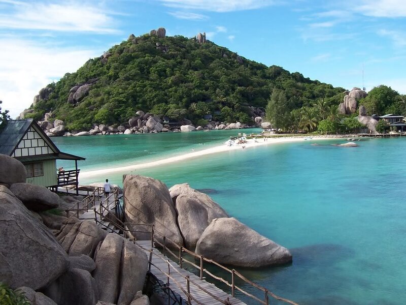 tropical beach with rocky island