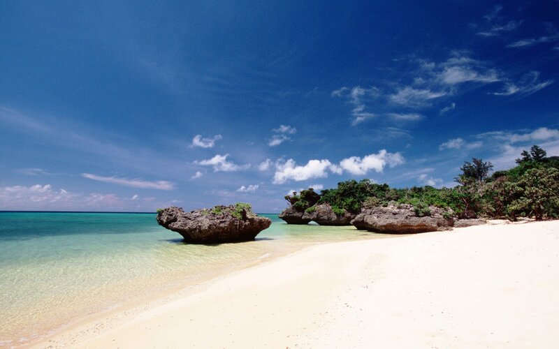 tropical beach with rocky outcrops